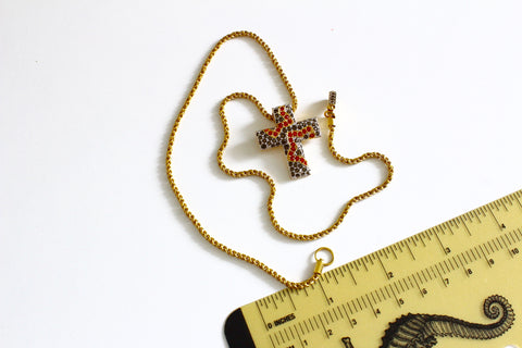 Swarovski gold tone chain with the cross shaped pendant Marked with Swan logo #976
