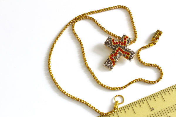Swarovski gold tone chain with the cross shaped pendant Marked with Swan logo #976