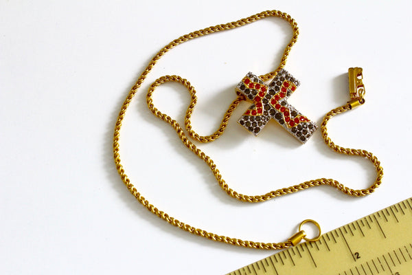 Swarovski gold tone chain with the cross shaped pendant Marked with Swan logo #976